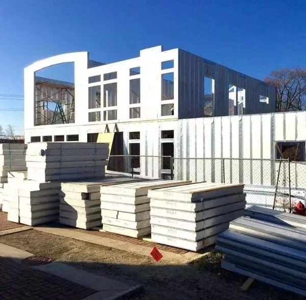 Structural insulated panels staged beside a Delaware building under construction