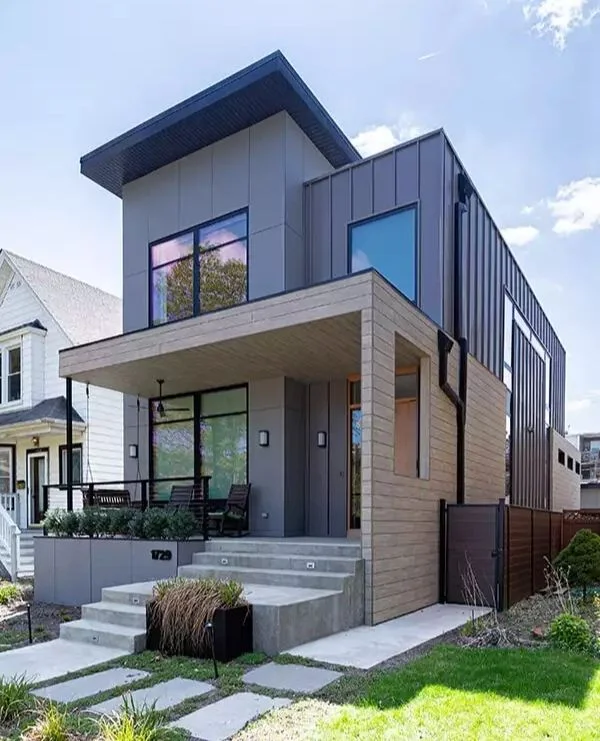Modern two-story SIP panel home with black metal siding