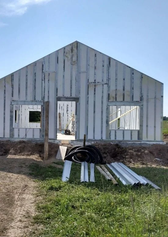 Finished brick building with continuous insulated metal roof