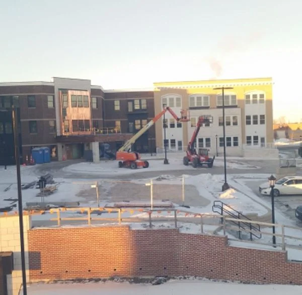 Multi-story commercial building under construction with lift equipment