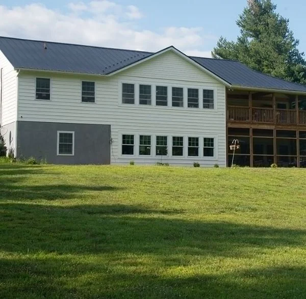 Finished two-story home with metal roof and screened porch