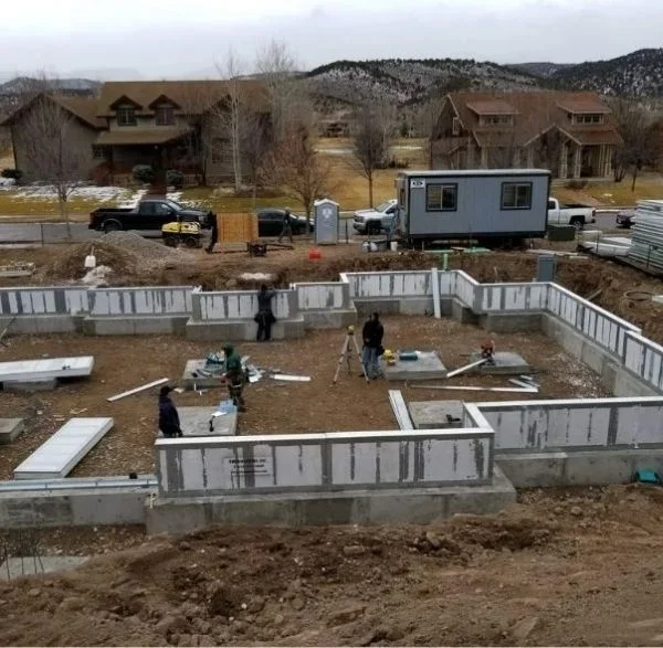 Ohio (3) Foundation walls under construction with workers surveying site