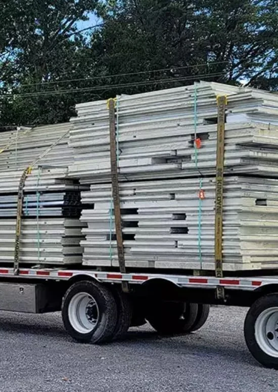 Flatbed truck loaded with strapped insulated panel bundles