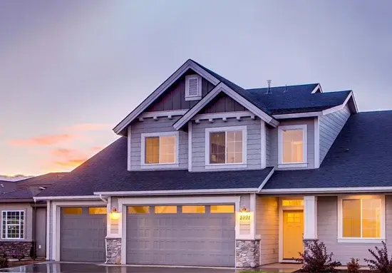 Untitled-1 Two-story suburban home with board-and-batten siding at dusk