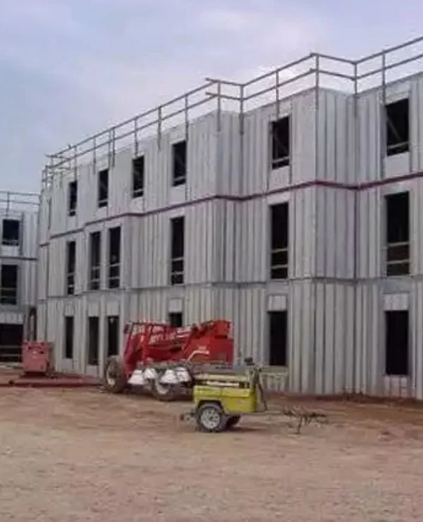 Multi-story panel building under construction with safety railings