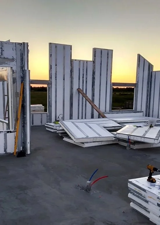 Insulated panel walls under construction at dusk