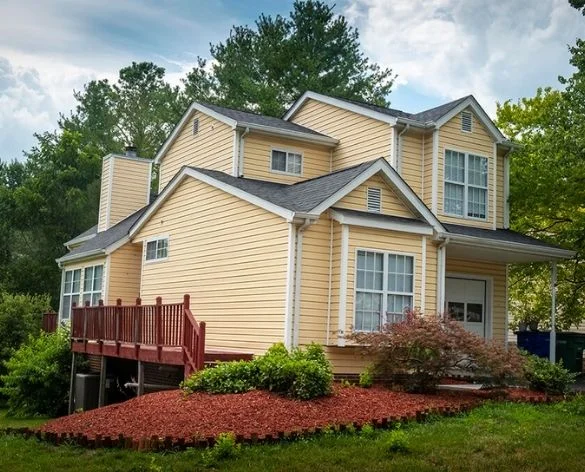 Washington DC (2) Two-story home with yellow siding and red wood deck