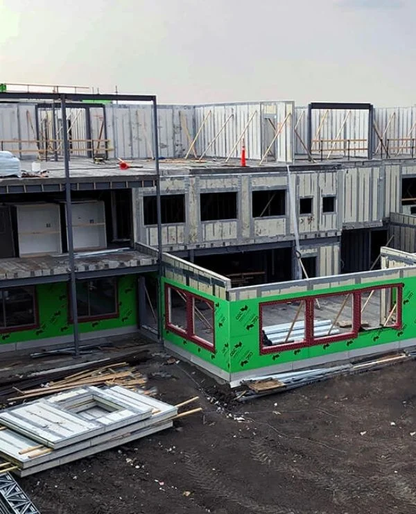 Washington DC Multi-story panel building under construction with green weather barrier