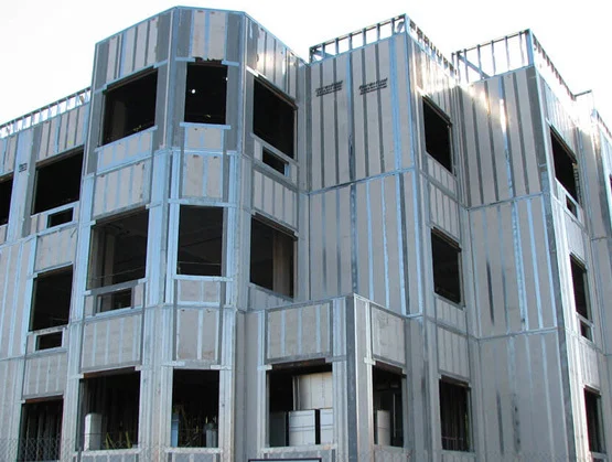 Multi-story building framed with structural insulated panels, showing window openings